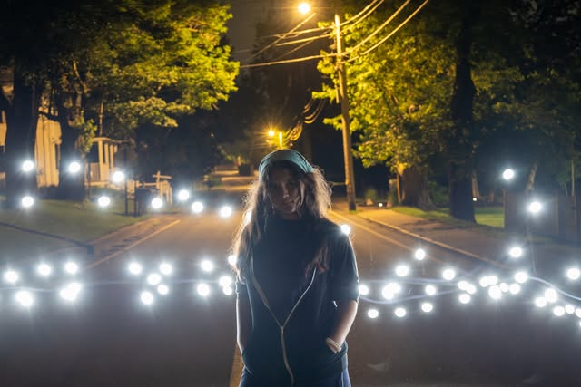 Night portrait on a street with glowing string lights and streetlights